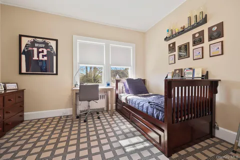 a bedroom with furniture and a window