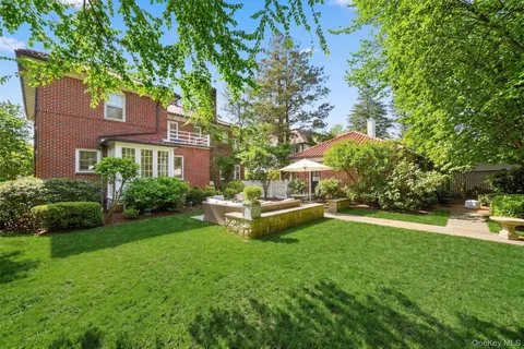 a view of a house with backyard porch and sitting area