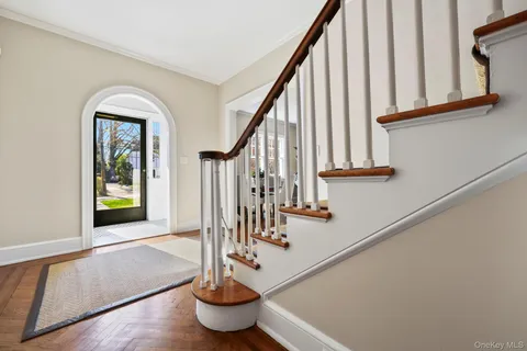 a view of entryway and hall with wooden floor