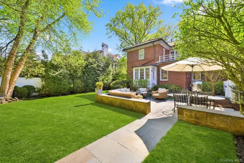 a view of a house with a yard patio and swimming pool