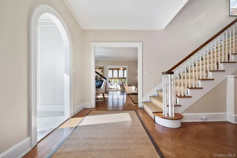 a view of entryway and hall with wooden floor