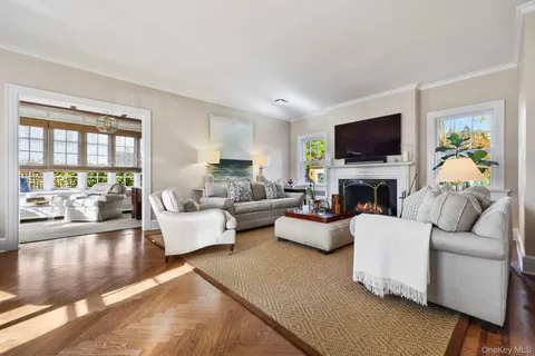 a living room with furniture a flat screen tv and a fireplace
