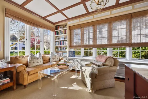 a living room with furniture and floor to ceiling windows