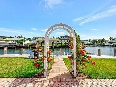 a swimming pool with outdoor seating and yard