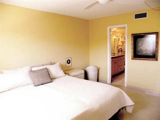 a spacious bathroom with a granite countertop sink a mirror and a bathtub