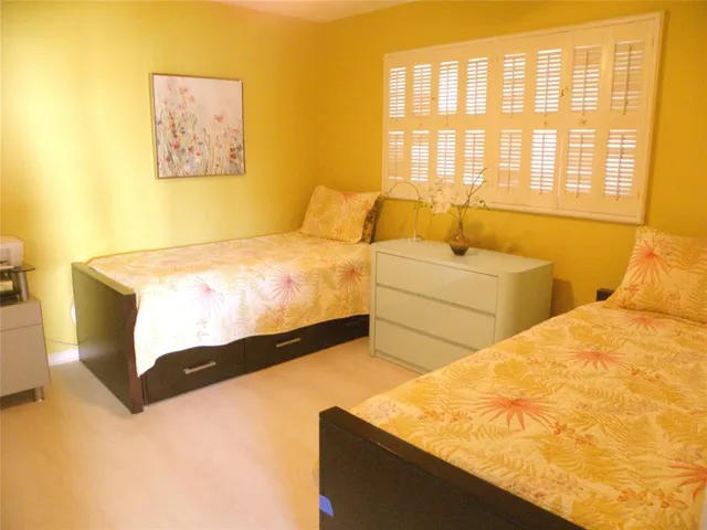 a view of a balcony with chair and wooden floor