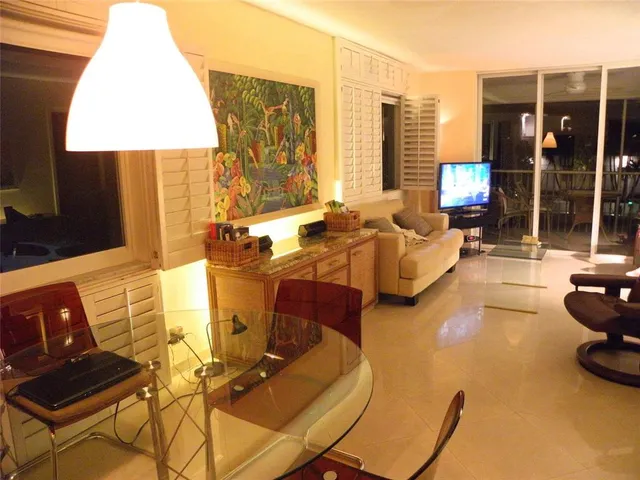 a kitchen with granite countertop a sink and a refrigerator
