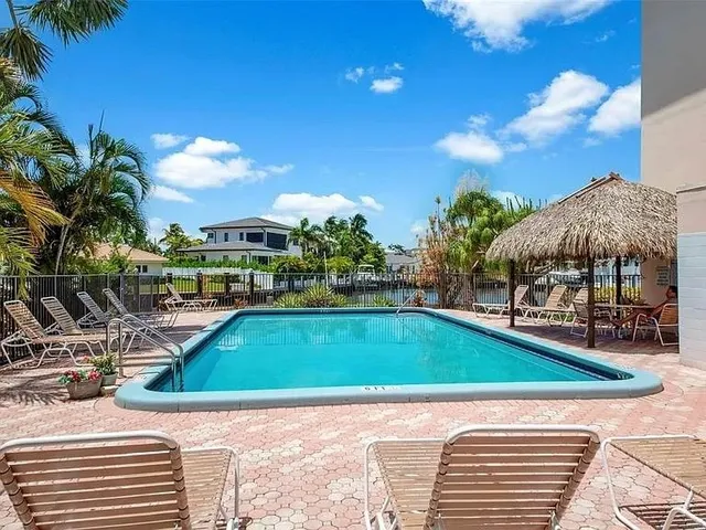 a view of swimming pool with outdoor seating and plants