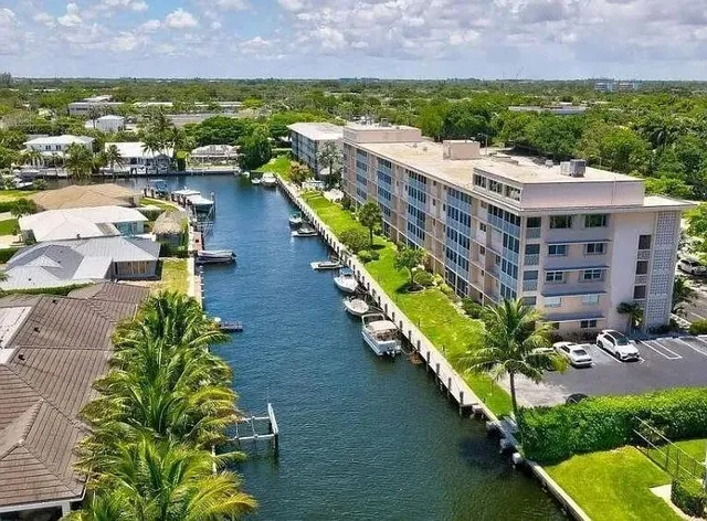 an aerial view of a house with a garden and lake view