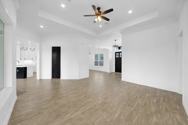 a view of an empty room with a kitchen