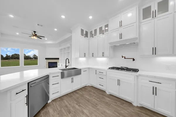 a kitchen with white cabinets and appliances