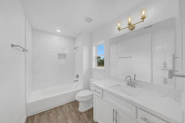 a bathroom with a sink double vanity granite toilet tub and shower