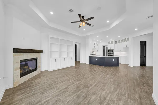 a view of a kitchen with a sink and a fireplace