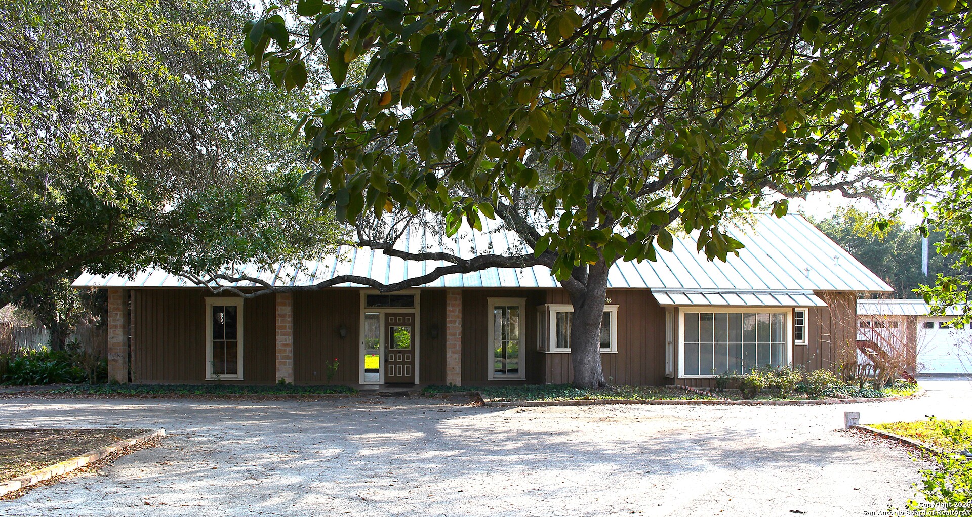 1111 Magnolia Street Uvalde, TX 78801 - Photo 1 of 34 a front view of a house with a tree in front