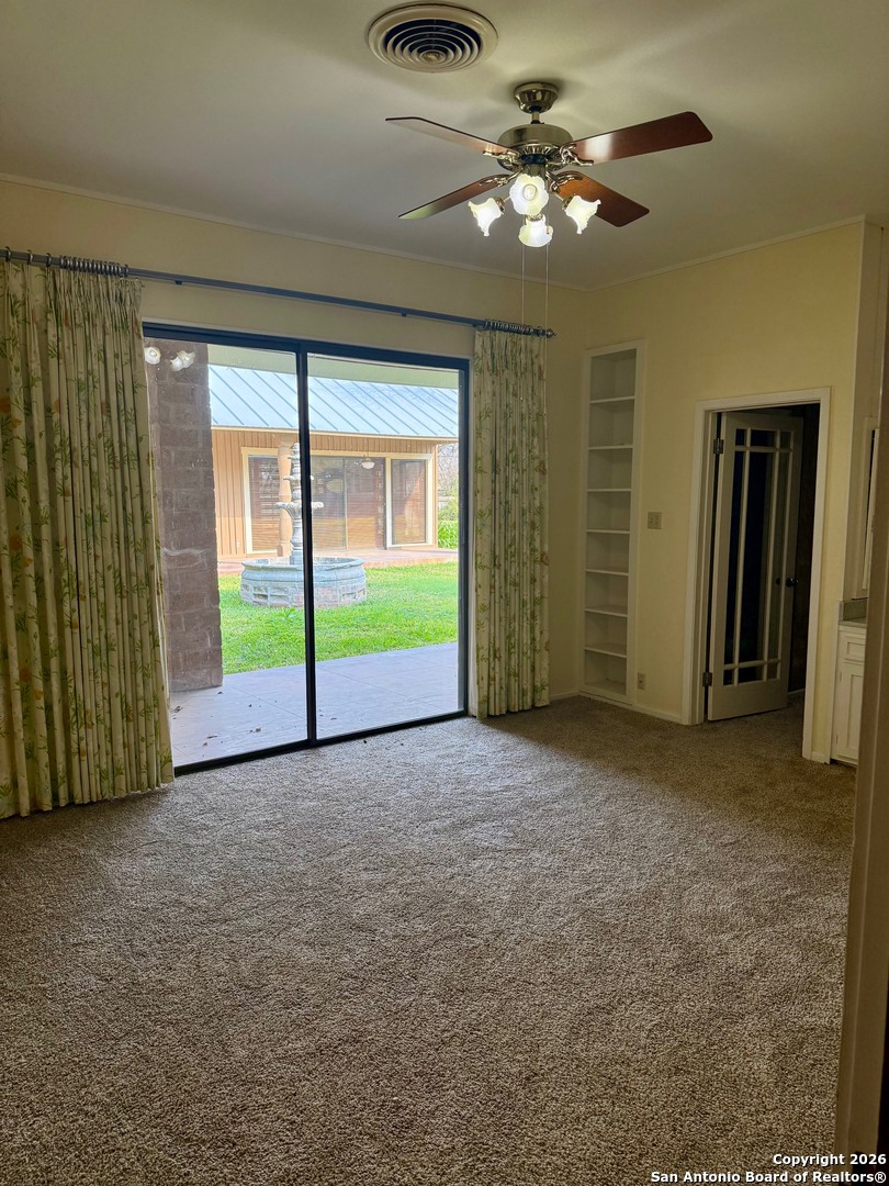 1111 Magnolia Street Uvalde, TX 78801 - Photo 18 of 34 a view of a livingroom with a ceiling fan and window
