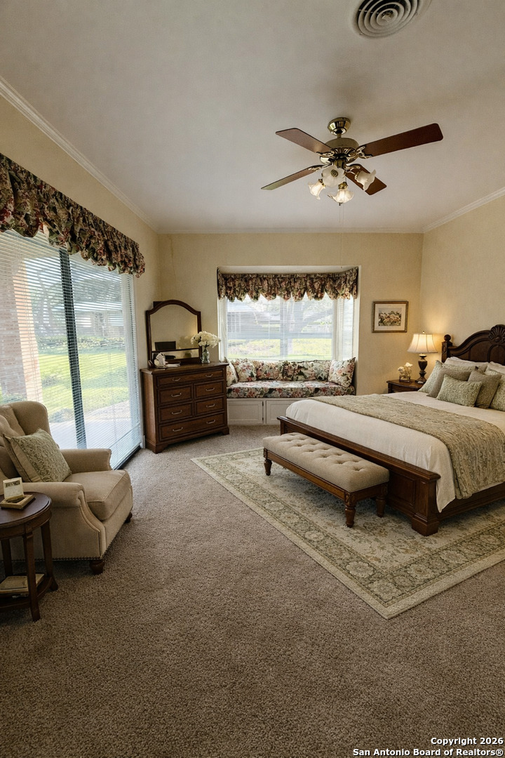 1111 Magnolia Street Uvalde, TX 78801 - Photo 21 of 34 a spacious bedroom with a bed and a couch