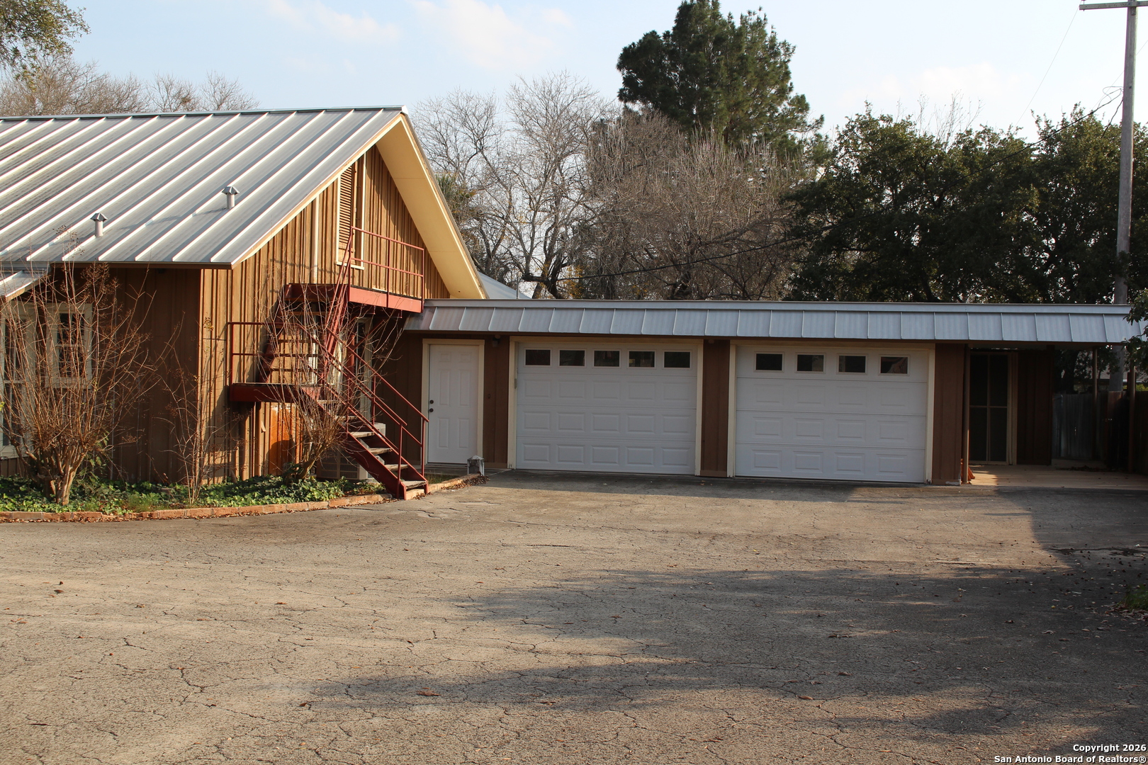 1111 Magnolia Street Uvalde, TX 78801 - Photo 3 of 34 a view of wooden house with large trees