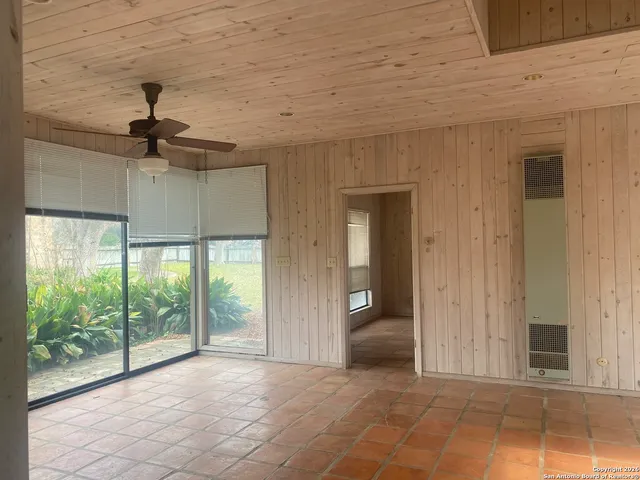 a view of a livingroom with a ceiling fan and window