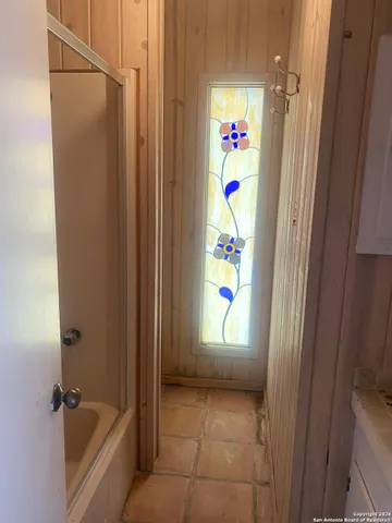 a bathroom with a bathtub and a shower