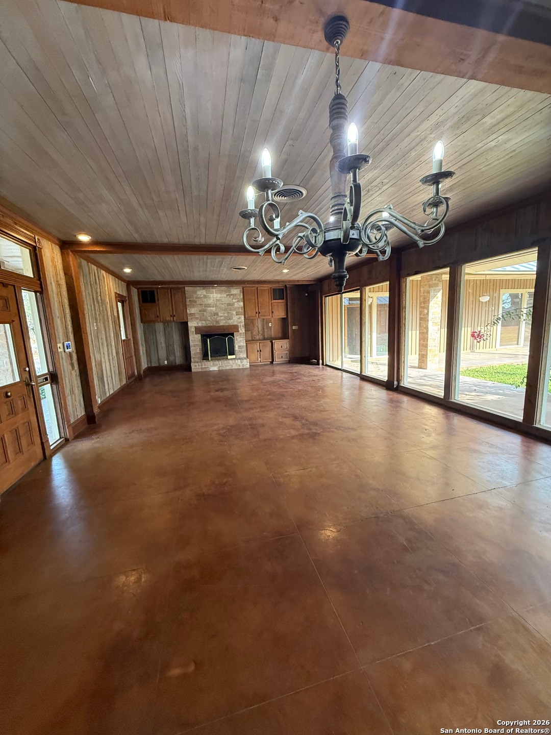 1111 Magnolia Street Uvalde, TX 78801 - Photo 5 of 34 a view of a hall with a flat screen tv