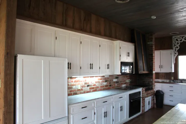 a kitchen with stainless steel appliances granite countertop a refrigerator sink and cabinets