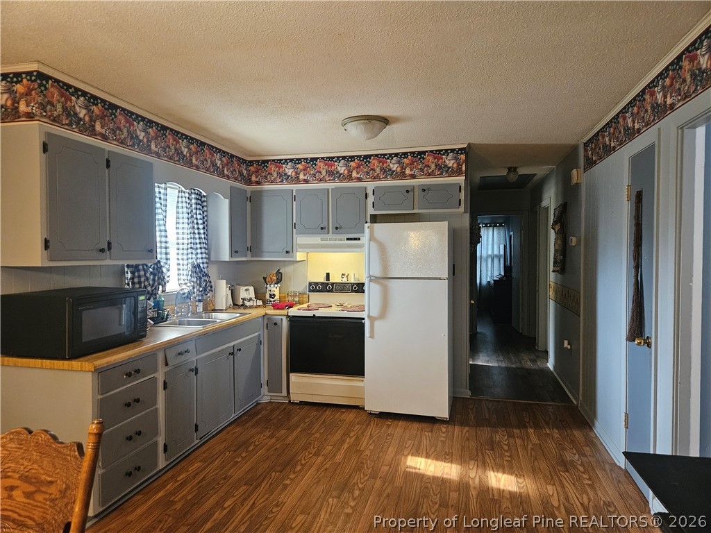 4547 Legion Road Hope Mills, NC 28348 - Photo 10 of 28 a kitchen with refrigerator and cabinets