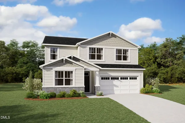 a front view of a house with a garden and yard