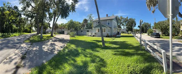 a view of a house with a backyard
