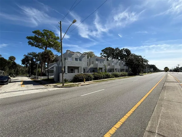 a view of a street with a building in the background