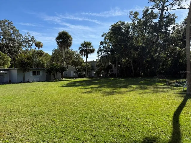 a view of a swimming pool with a yard