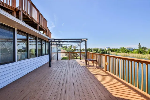 a view of a balcony with wooden floor and fence