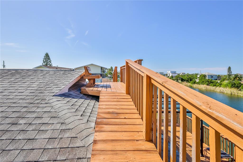 3397 Crape Myrtle Drive Hernando Beach, FL 34607 - Photo 19 of 76 a view of a balcony with wooden floor and fence