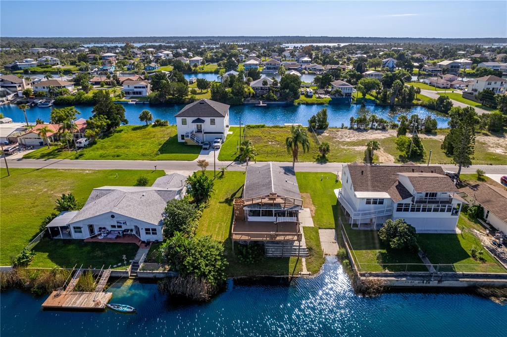 3397 Crape Myrtle Drive Hernando Beach, FL 34607 - Photo 44 of 76 an aerial view of a house with a swimming pool yard and outdoor seating