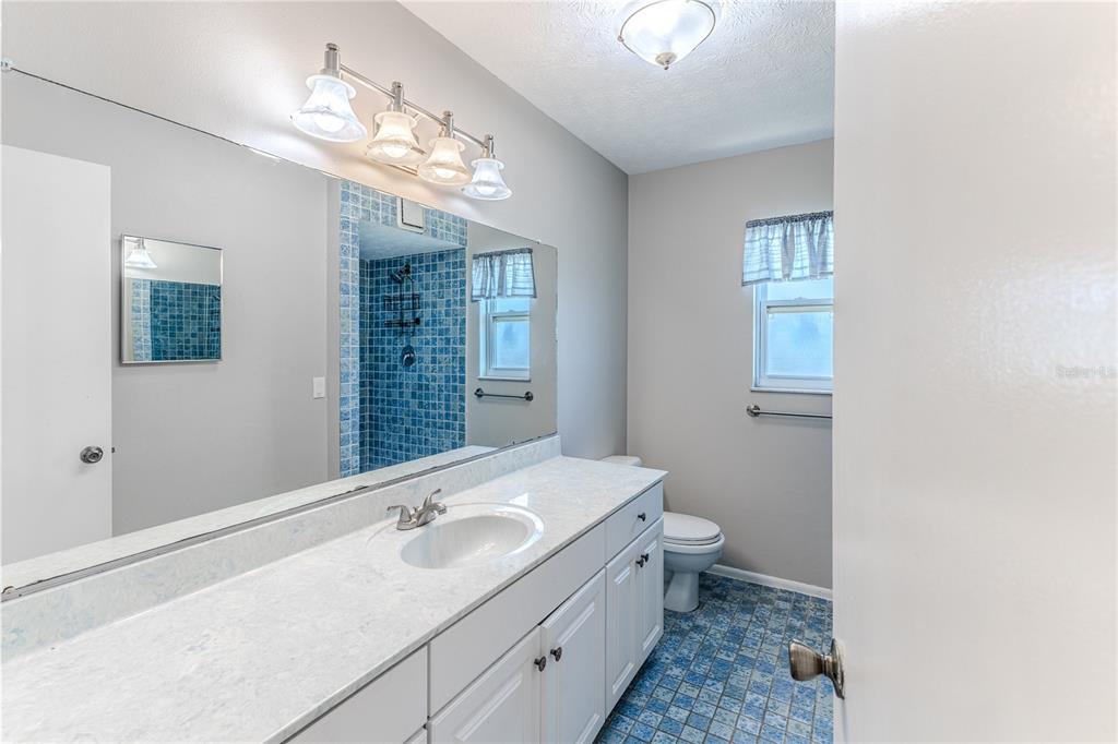 3397 Crape Myrtle Drive Hernando Beach, FL 34607 - Photo 48 of 76 a bathroom with a double vanity sink and a toilet