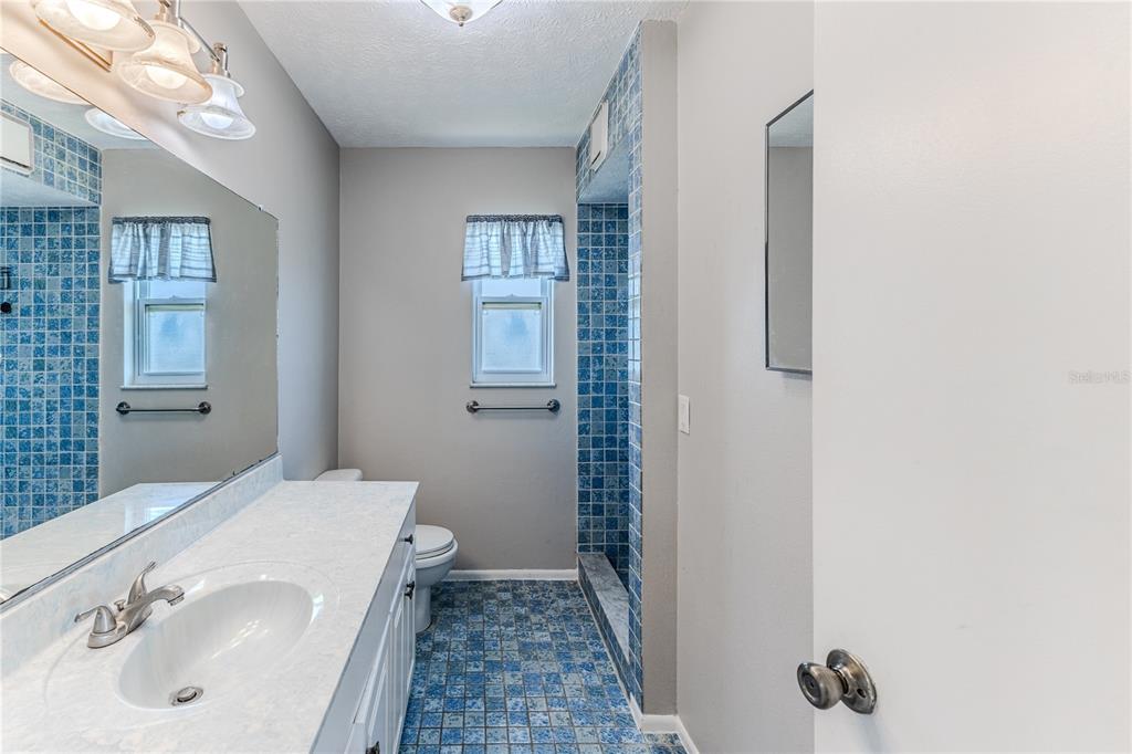 3397 Crape Myrtle Drive Hernando Beach, FL 34607 - Photo 49 of 76 a bathroom with a sink and a mirror
