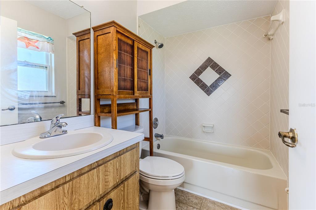 3397 Crape Myrtle Drive Hernando Beach, FL 34607 - Photo 57 of 76 a bathroom with a sink a toilet and shower