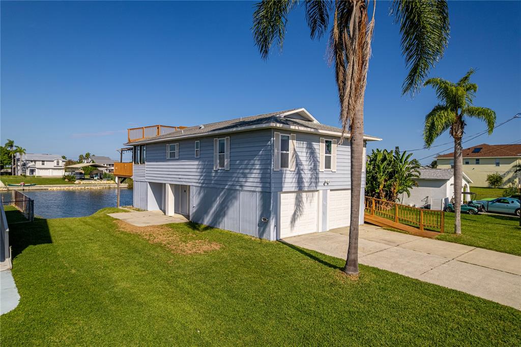 3397 Crape Myrtle Drive Hernando Beach, FL 34607 - Photo 75 of 76 a view of a house with backyard porch and sitting area