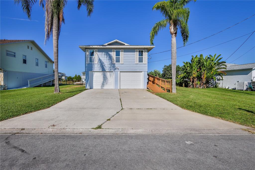 3397 Crape Myrtle Drive Hernando Beach, FL 34607 - Photo 76 of 76 a view of a house with a yard and potted plants
