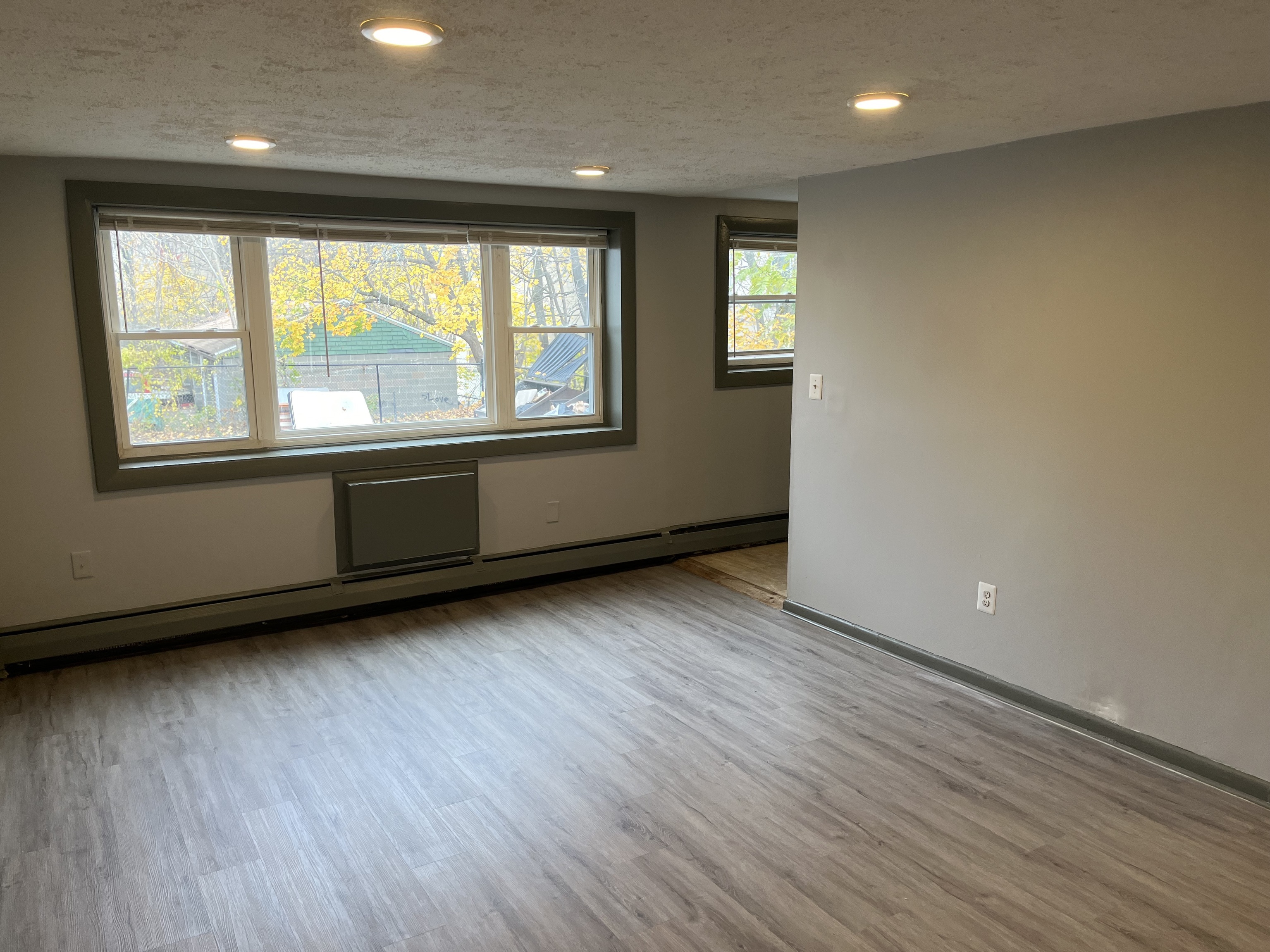 32 Cook Avenue, Unit 106 Meriden, CT 06451 - Photo 2 of 8 an empty room with wooden floor and windows