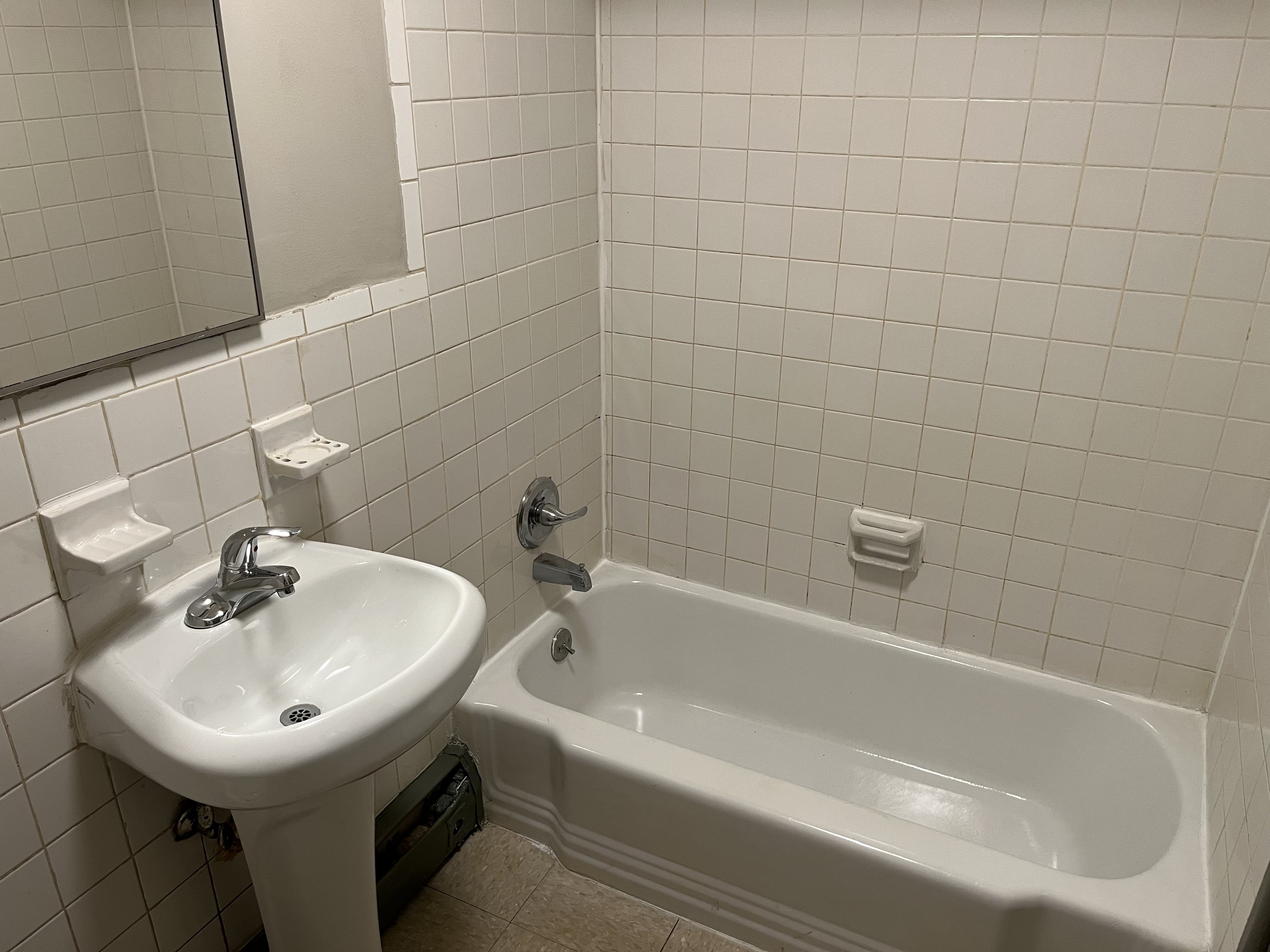 32 Cook Avenue, Unit 106 Meriden, CT 06451 - Photo 6 of 8 a white bath tub sitting next to a white sink