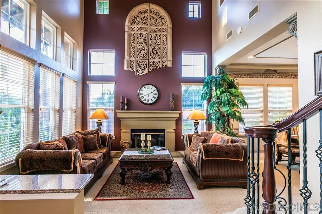 11683 Eastfield Road Poway, CA 92064 - Photo 3 of 21 a living room with furniture a rug a fireplace and a large window