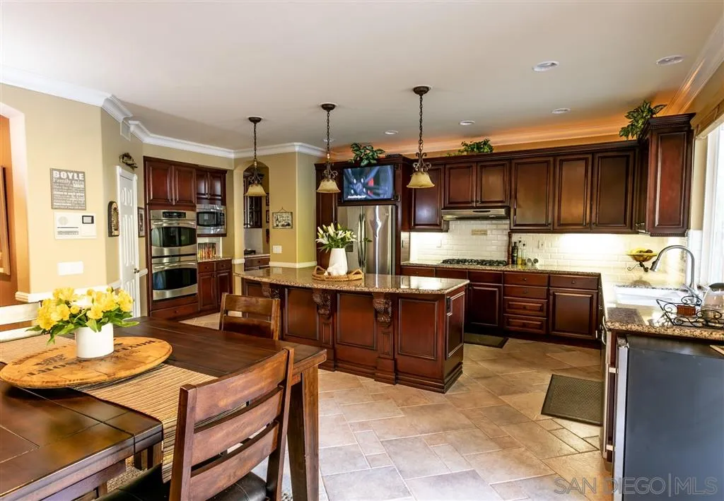 11683 Eastfield Road Poway, CA 92064 - Photo 6 of 21 a kitchen with a refrigerator and a stove top oven