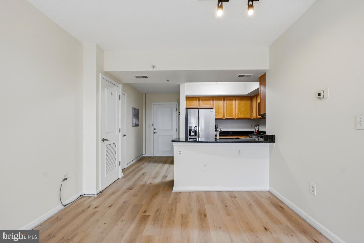 7915 Eastern Avenue Northwest, Unit 1208 Silver Spring, MD 20910 - Photo 8 of 33 a view of a kitchen with wooden floor