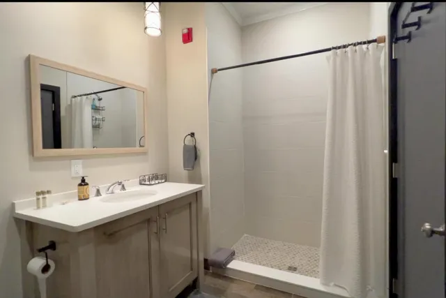 a bathroom with a sink a toilet and a mirror