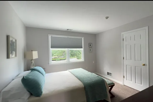 a living room with lots of furniture and kitchen view