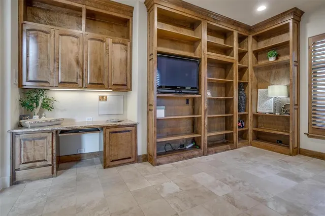 a view of an empty room with a cabinet and a window