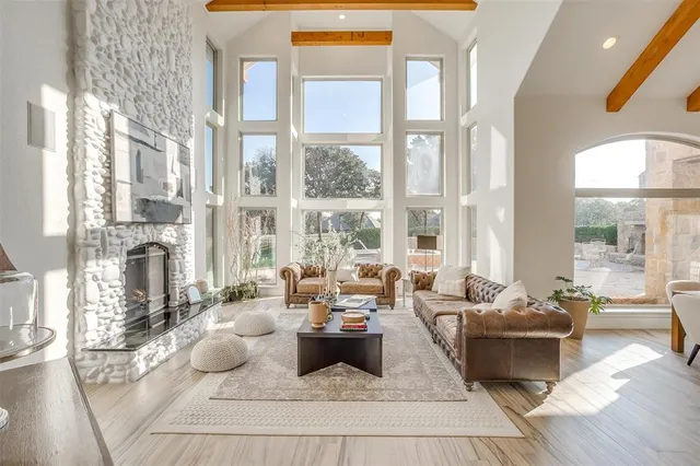 a living room with furniture and large windows