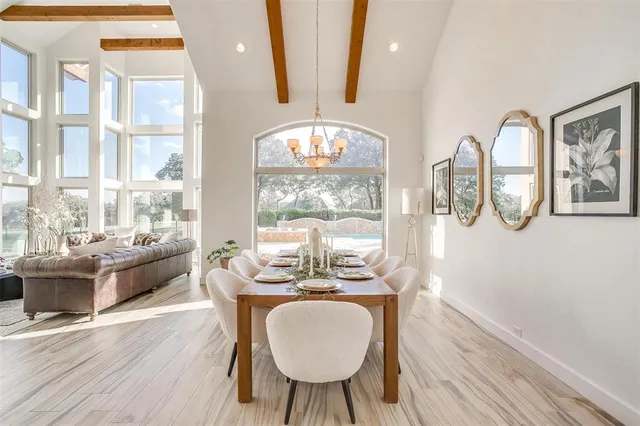 a dining room with wooden floor and a chandelier