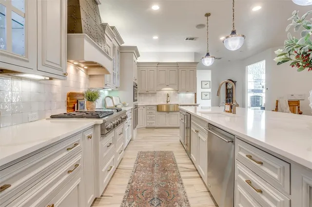 a large kitchen with a lot of counter space and a sink