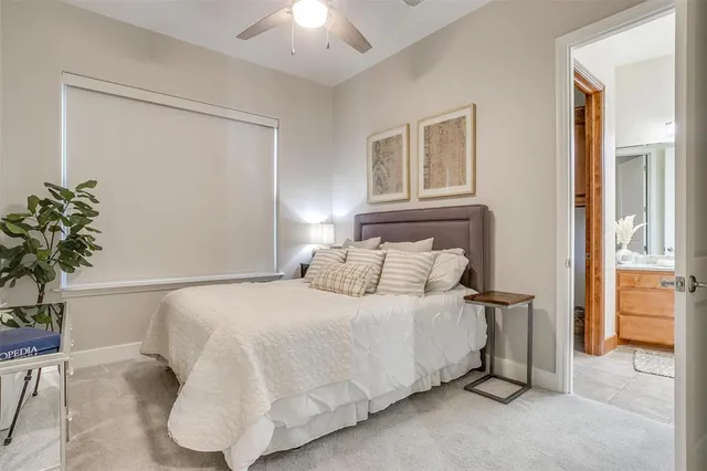 a spacious bedroom with a bed and a chandelier
